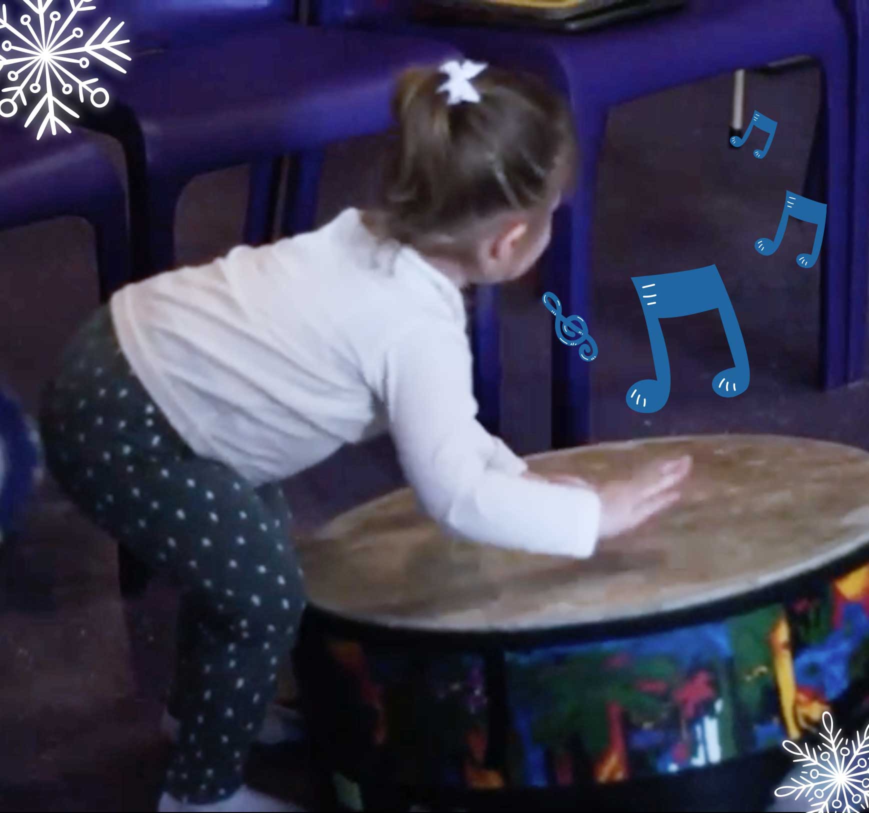 Little girl playing a drum