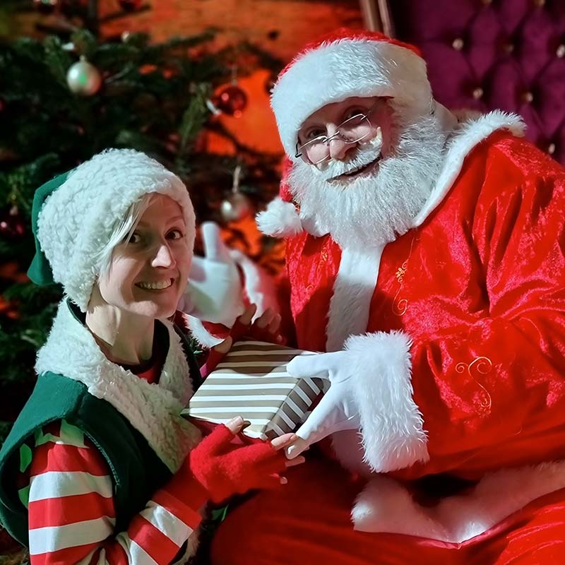 Santa sitting with an Elf